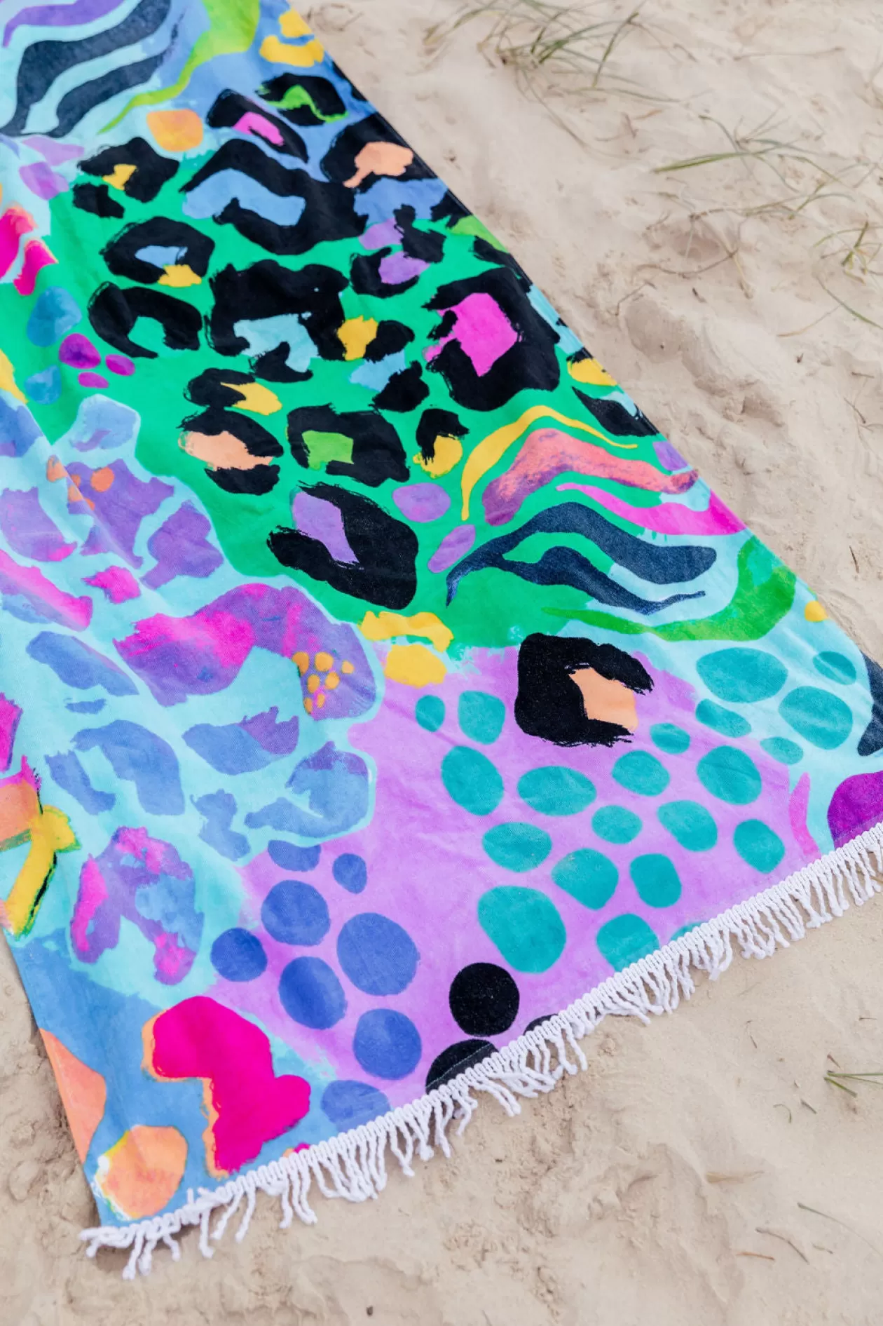 Proud Poppy Clothing Beach Towel in Electric Leopard by Kasey Rainbow